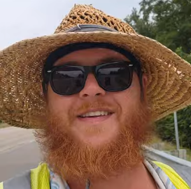 Man with hat, sunglasses, big red beard and moustache, unbuttoned shirt