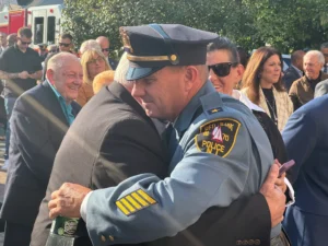 Red Bank Police Chief Mike Frazee hugs his father, Michael Sr. following his swearing-in ceremony. (Photo by Brian Donohue)